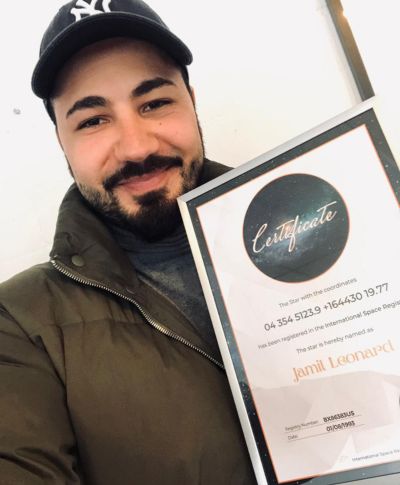 Young man holding his star-naming certificate